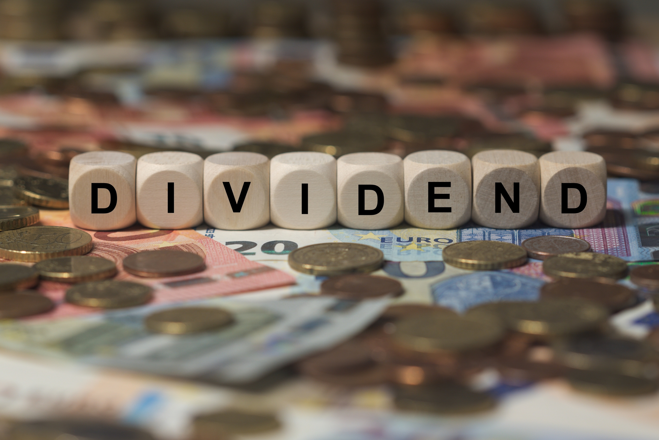 dividend cube with letters money sector terms sign with wooden cubes 85375734